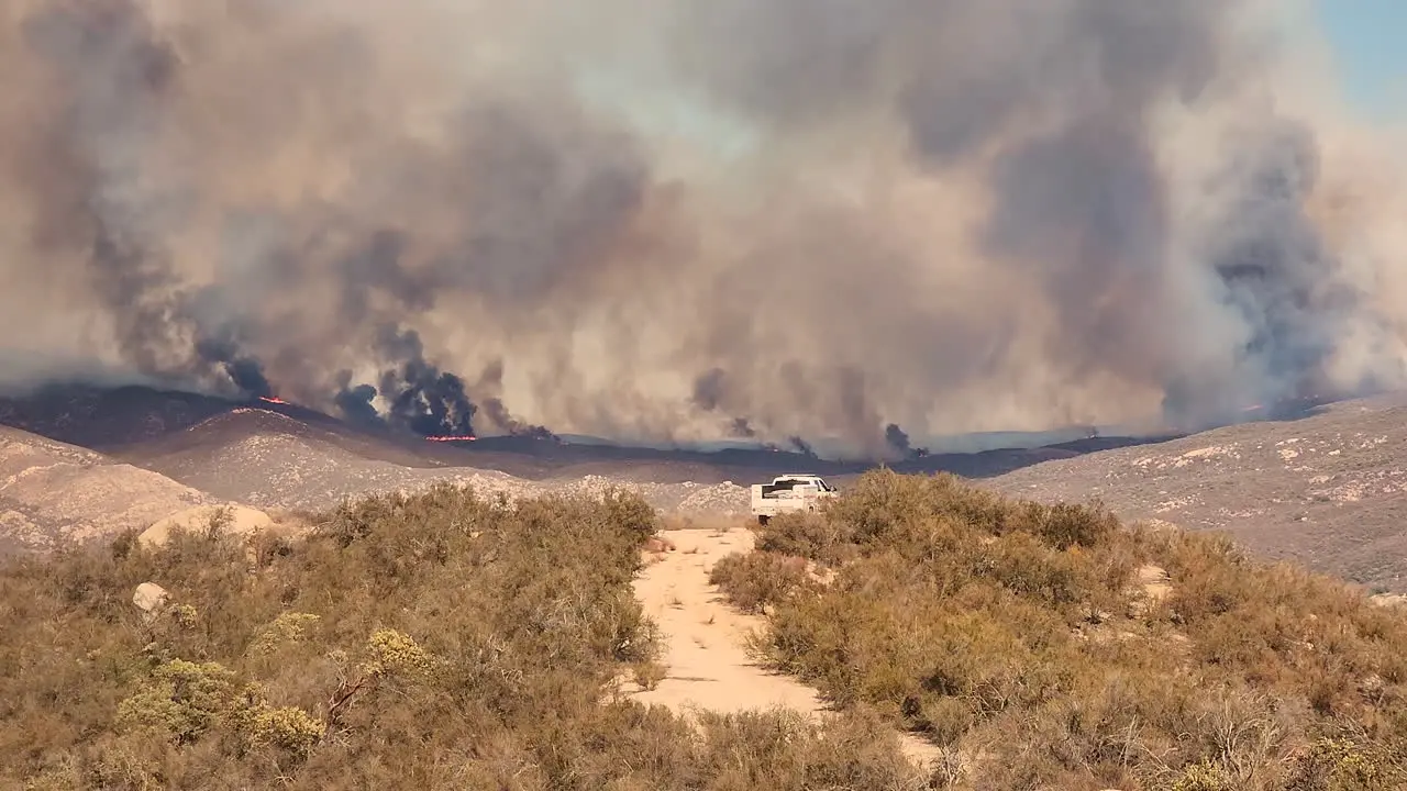 Line of fire in the valley and rescue vehicle driving to the rescue