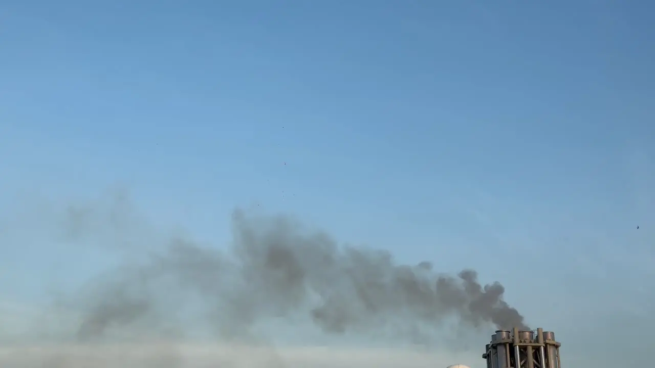 Funnel of a cruise ship smokestack expel boiler steam and smoke into the air