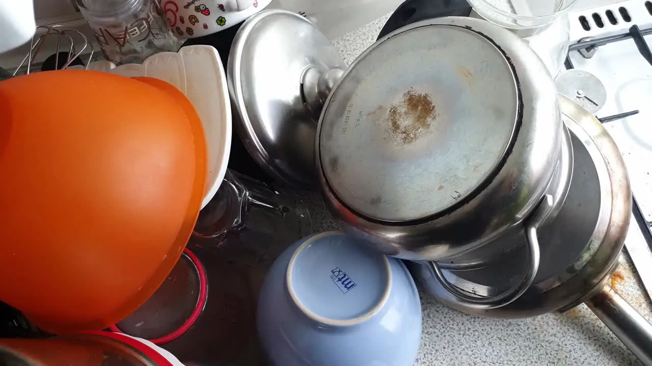 pile of washed Dishes On A Sink Drainer