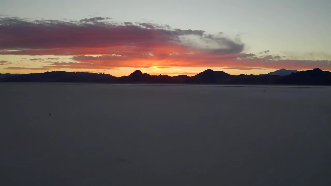 Epic picturesque fire sunset at bonneville salt flats aerial dolly