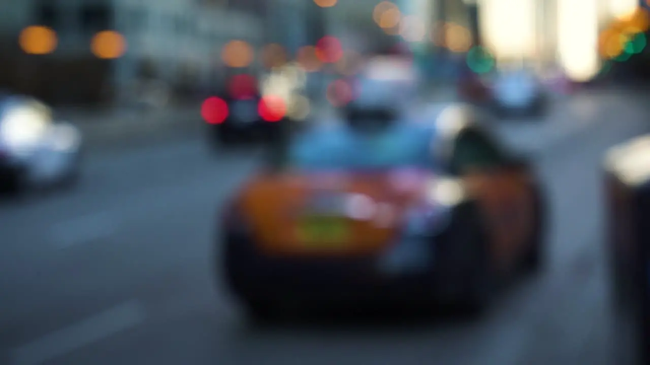 A blurred megapolis' street where a woman is taking a taxi and driving away during the winter in Chicago IL