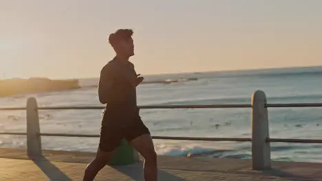 Man music earphones or running by sunset beach