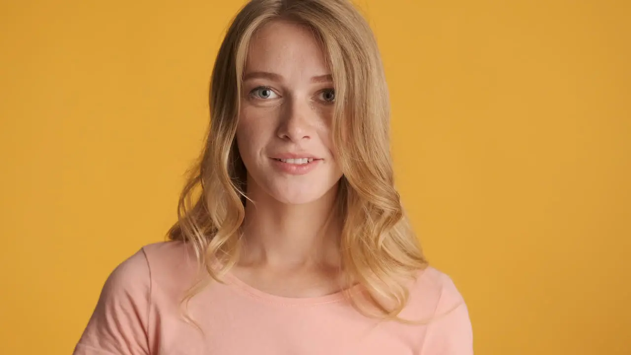 Caucasian woman calmly looking and smiling at camera