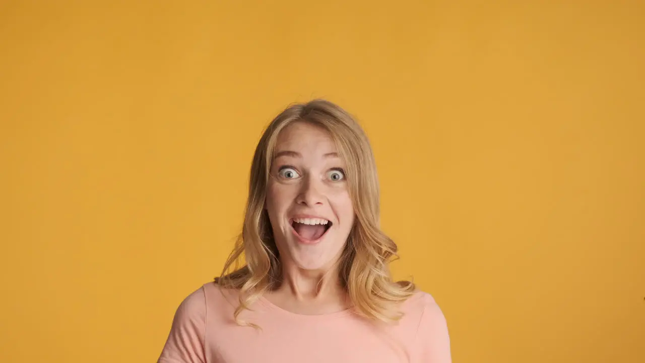 Caucasian woman looking up and getting surprised on camera