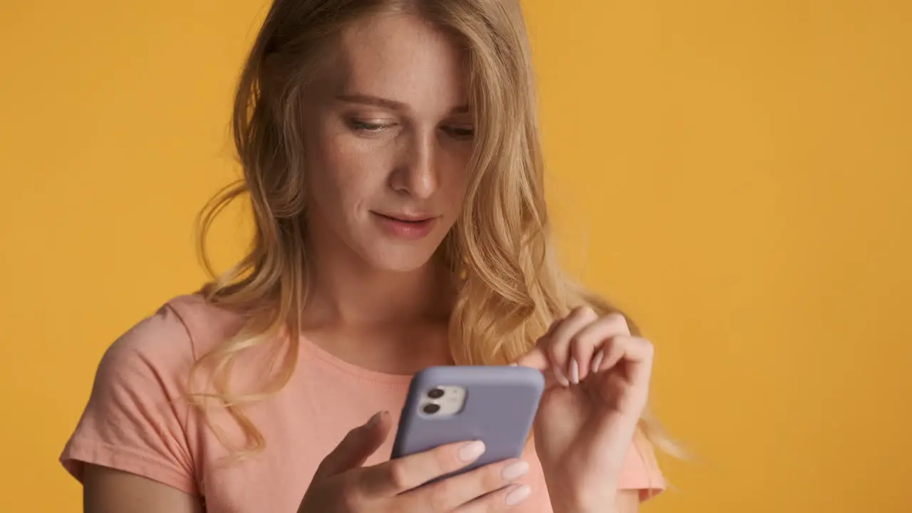 Caucasian woman using smartphone and smiling