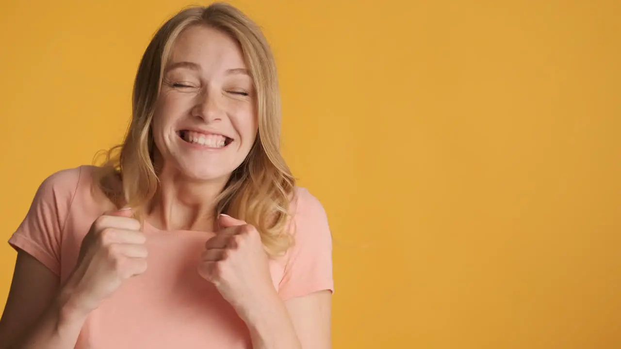 Caucasian woman getting excited and showing thumbs up on camera