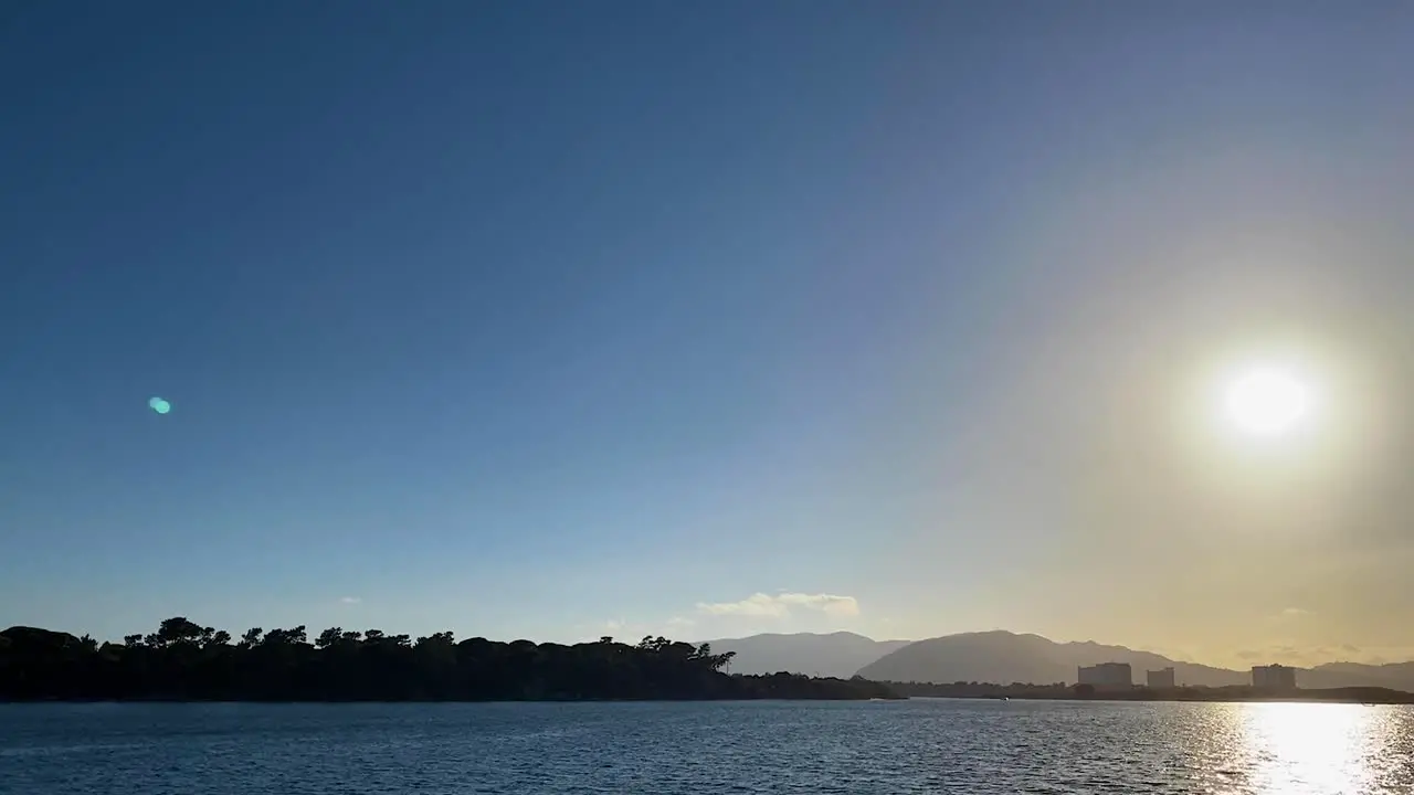 Troia Island and incredible sun in the middle of the atlantic ocean with arrabida mountains behind