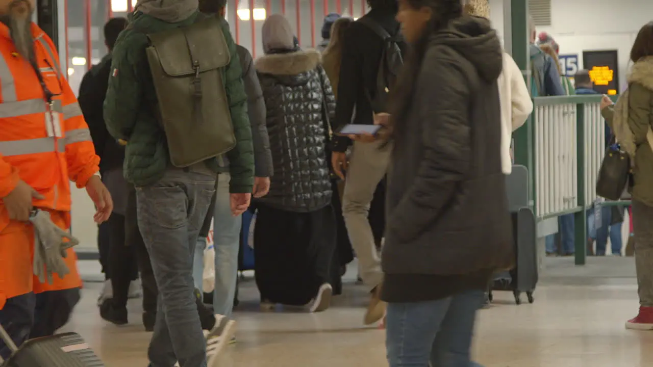 Commuters walking towards train platform