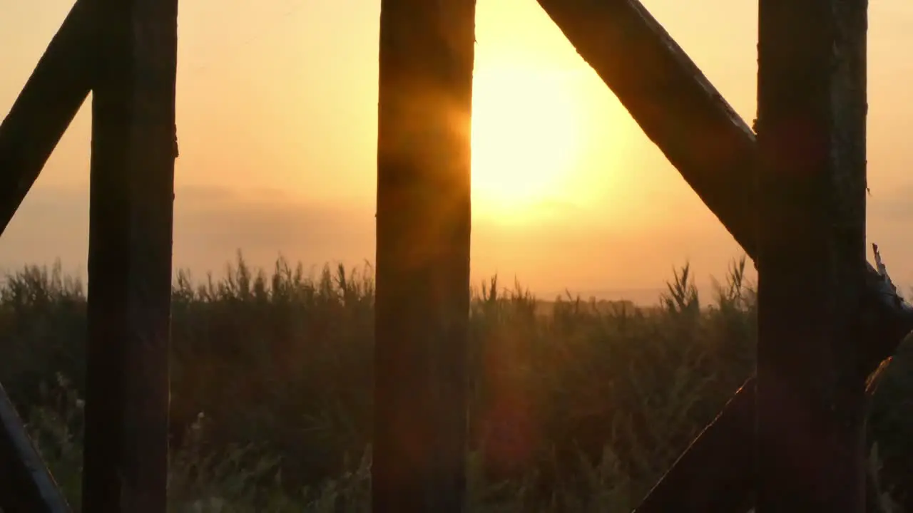 A view of the sunset through the gates in a summer day