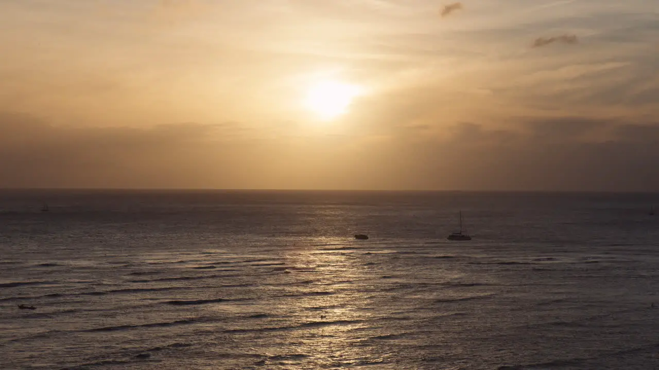 Low Sunset Golden Hour at Waikiki Bay Ships on Horizon Amid Ocean Waves Hawaii