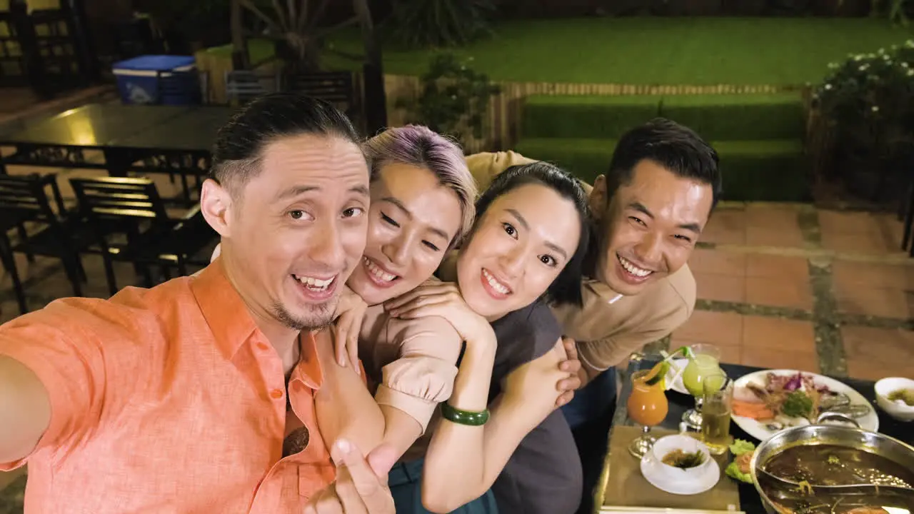 Young friends recording themselves on chinese restaurant