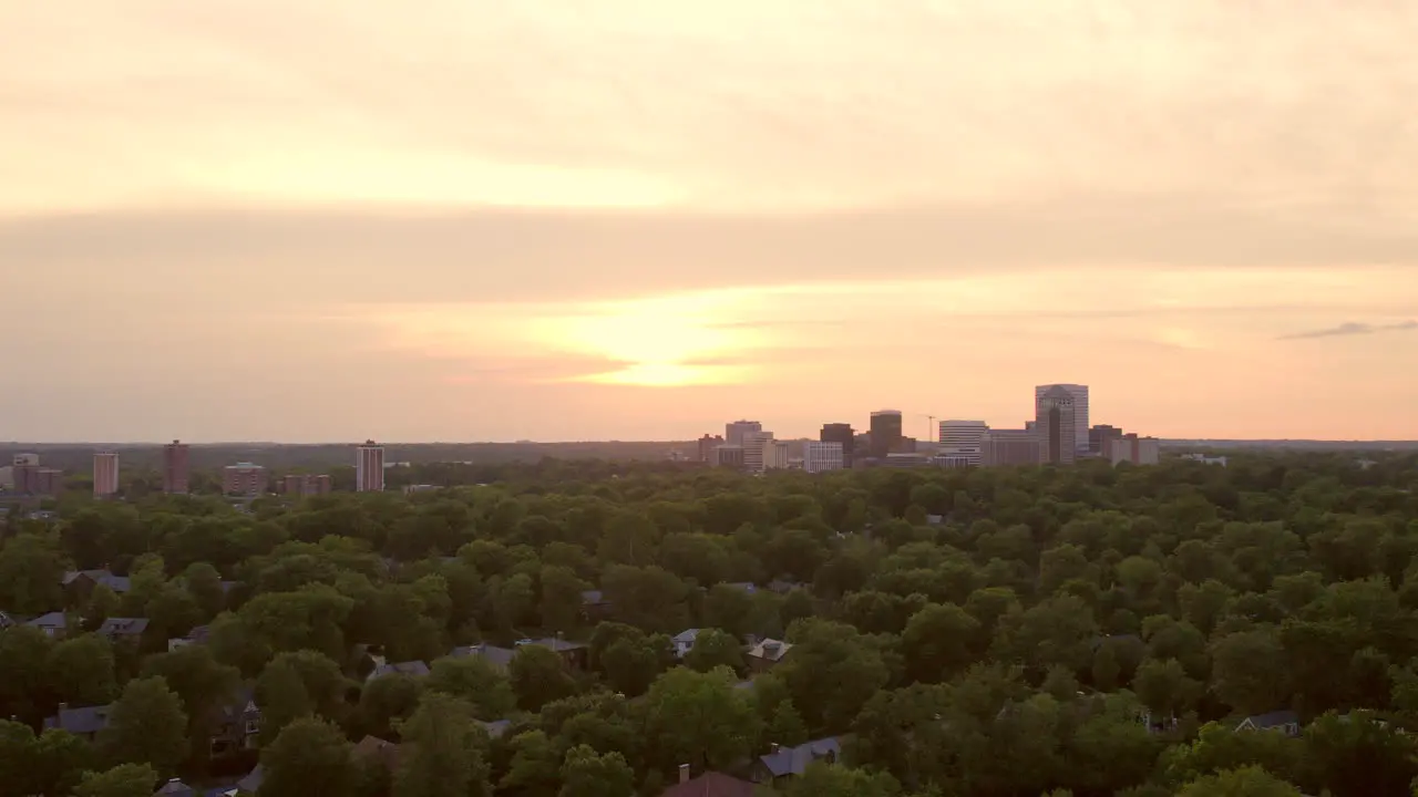 Downtown Clayton city skyline on horizon at sunset on a pretty evening with a slow descent down