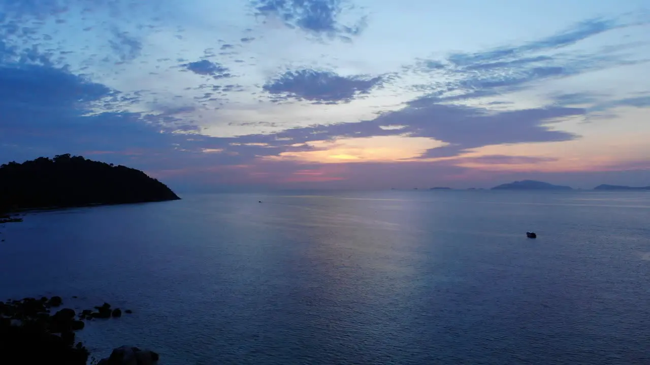 View of the ocean with boats and colorfull sunset