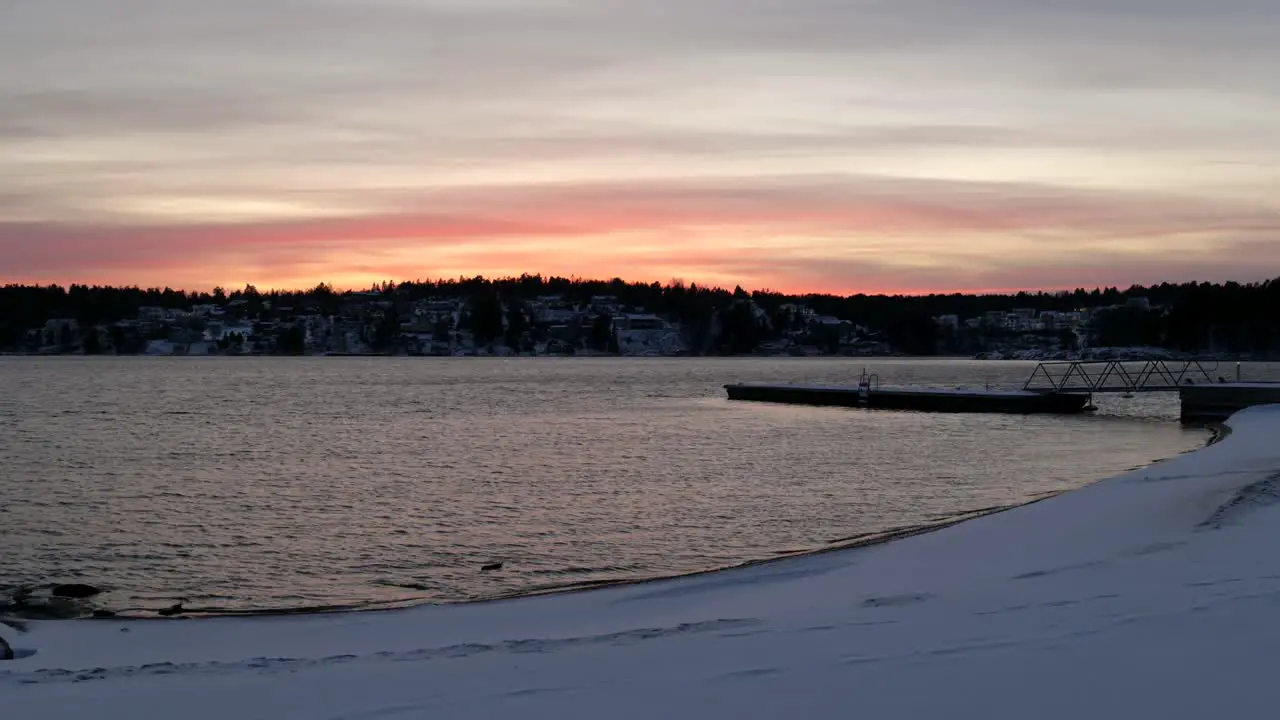 snowy landscape at the end of the day near a lake