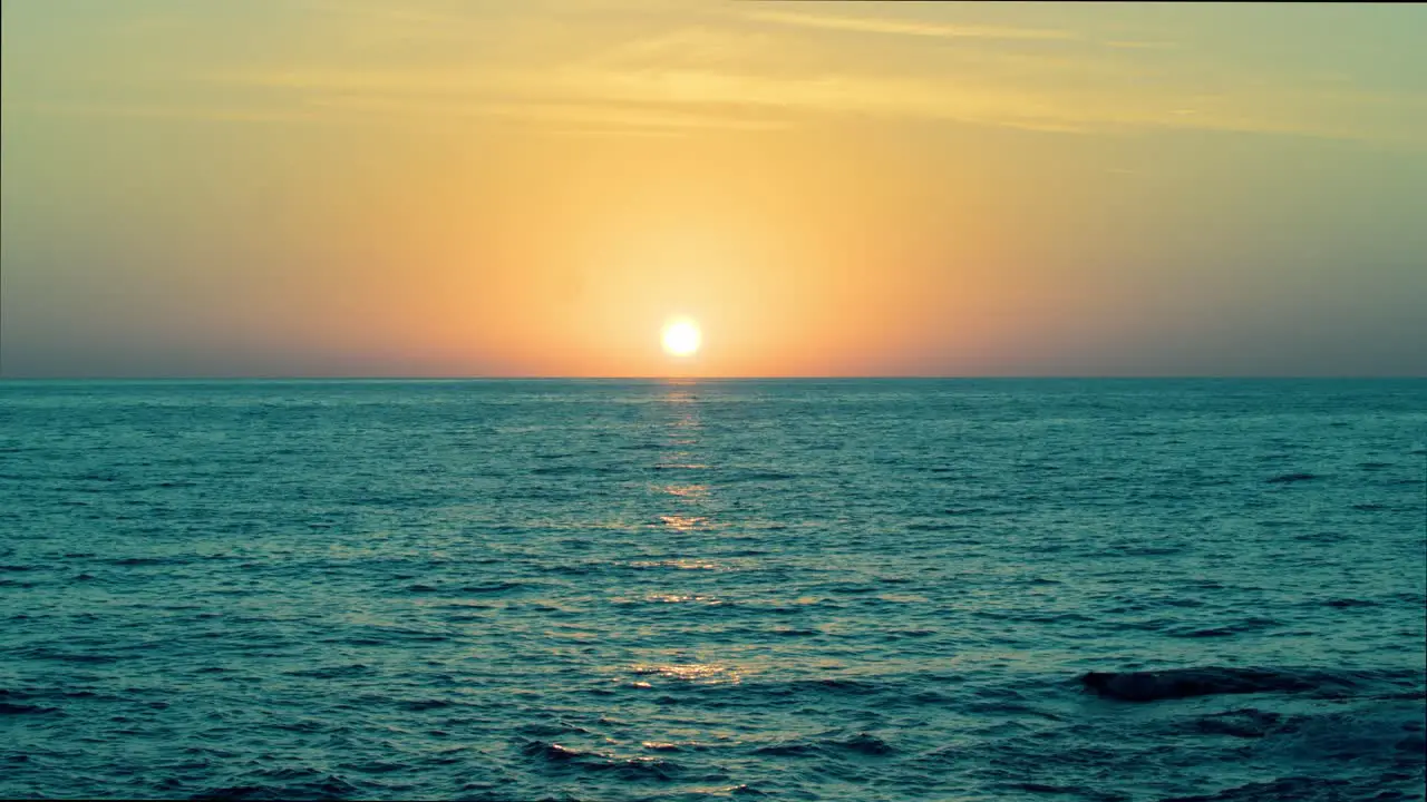 Romantic golden hour sunset sky and mediterranean blue sea in slow motion wide shot