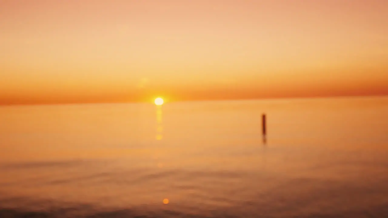 Woman Shows Her Heart Shape On The Background Of The Sea Where The Sun Goes Down