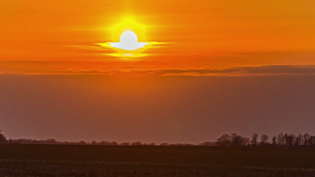 Golden Yellow Setting Sun Against Orange Skies Timelapse Static Shot