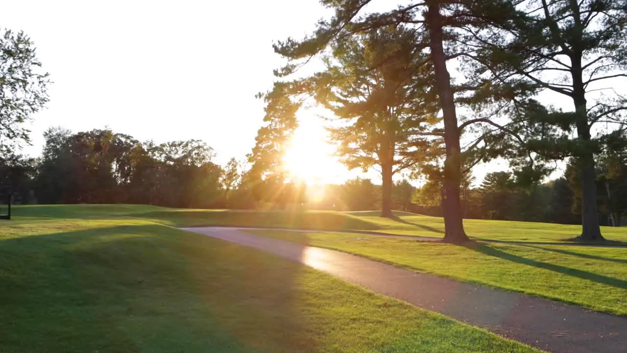 I smooth slow motion shot of the sunset on a golf course