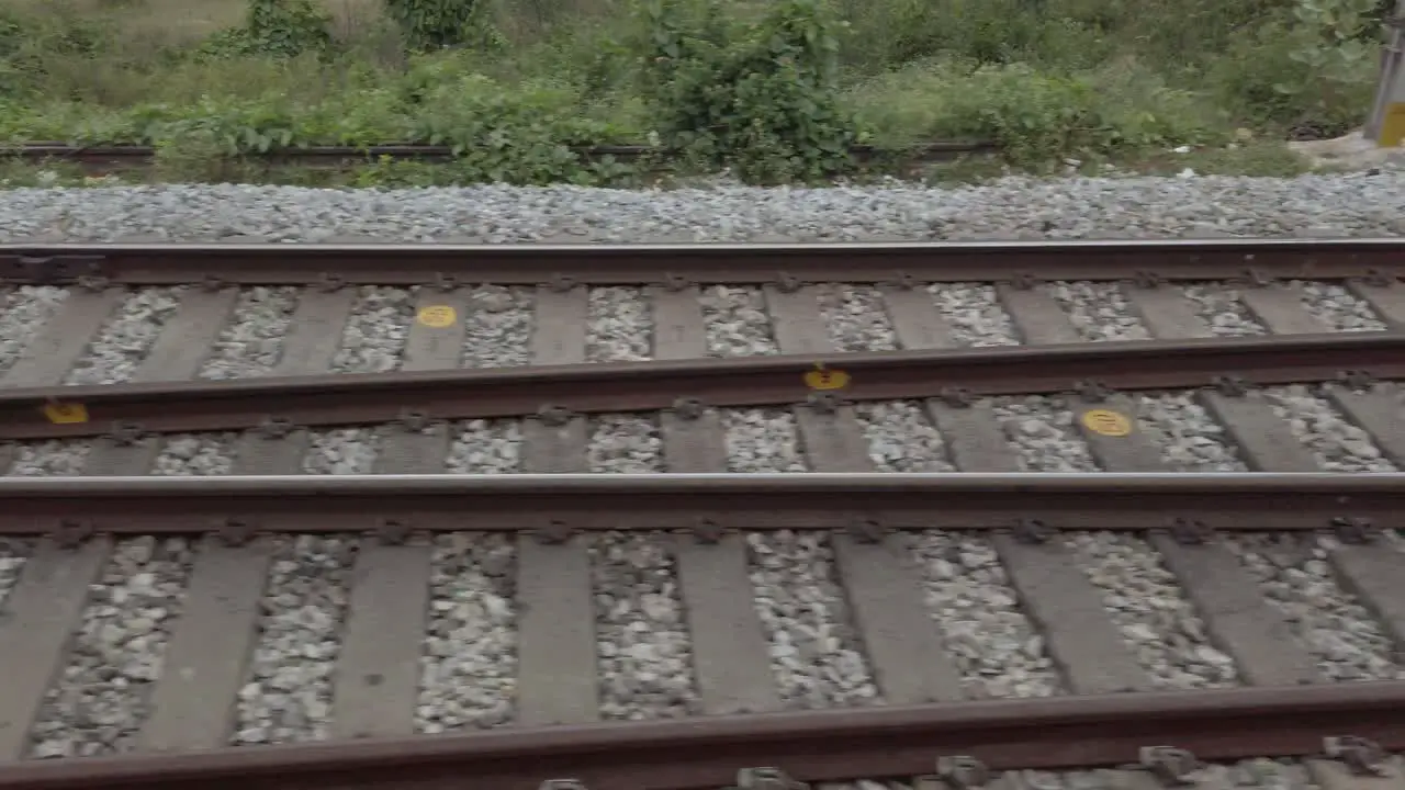 Closeup of the railway tracks from a fast moving train during daytime