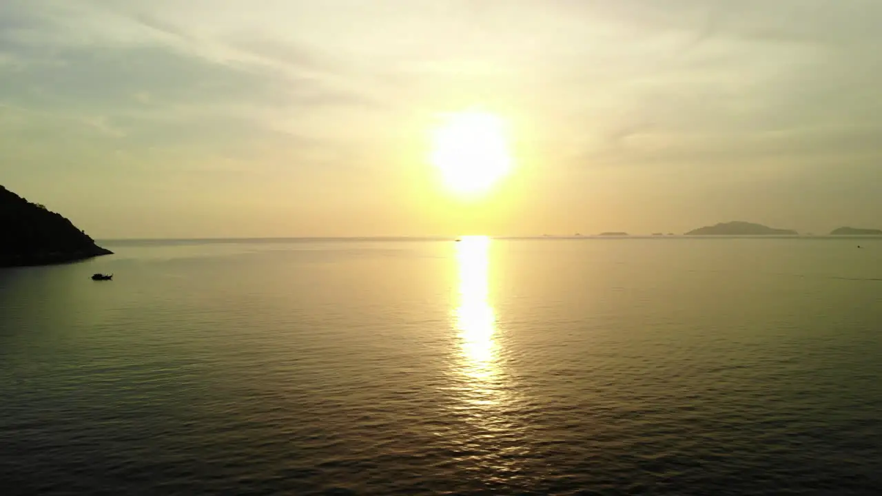 Flight over the ocean with golden sunset on the background