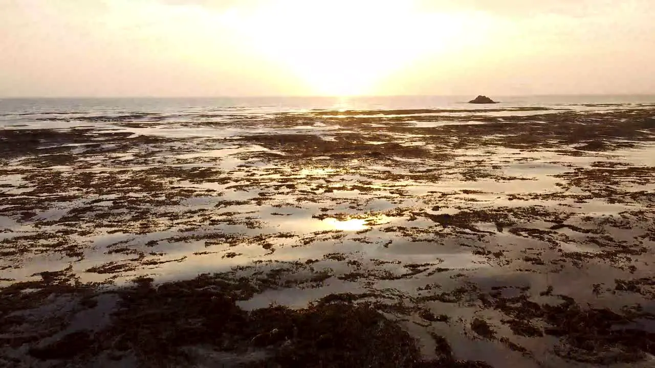 Beautiful tilt up drone shot of a sunset in the beach