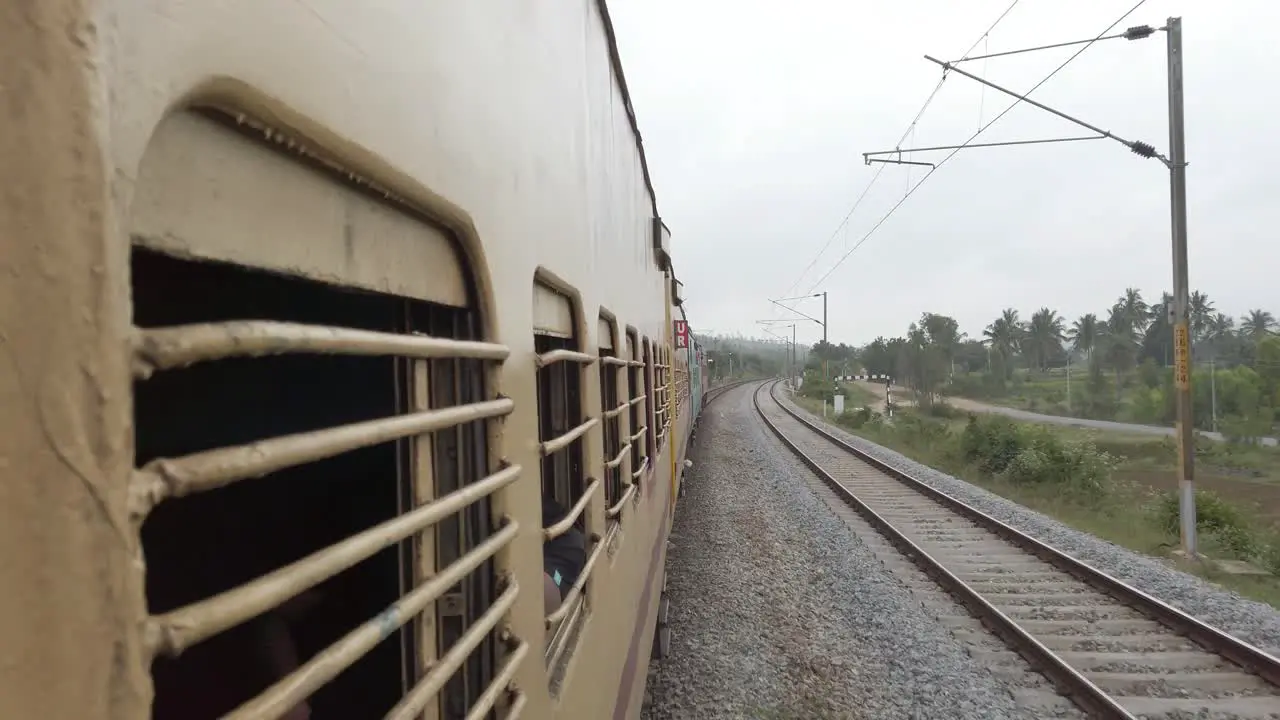 Aambur Tamilnadu India December 14 2019 View from the window of a interstate train travelling at high speed on a straight track on an overcast day