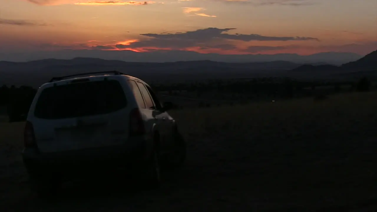 A simple clip of a SUV driving off with Sunset in the Background