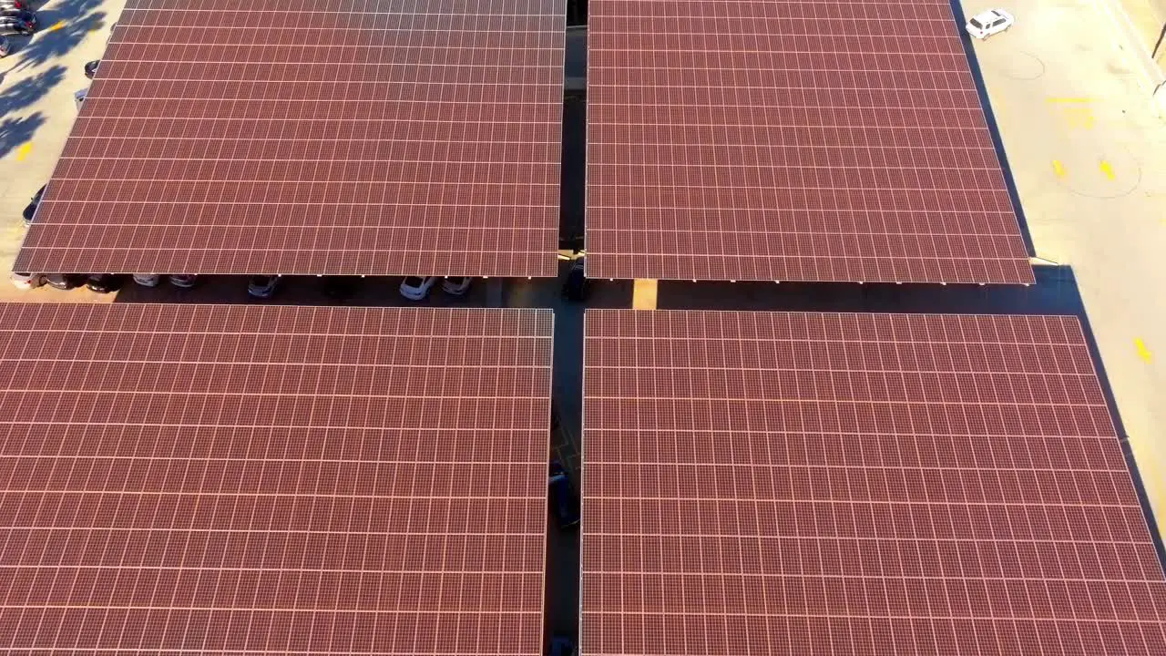 Ascending Aerial of large solar panels with orange Motion Graphics overlay technology concept