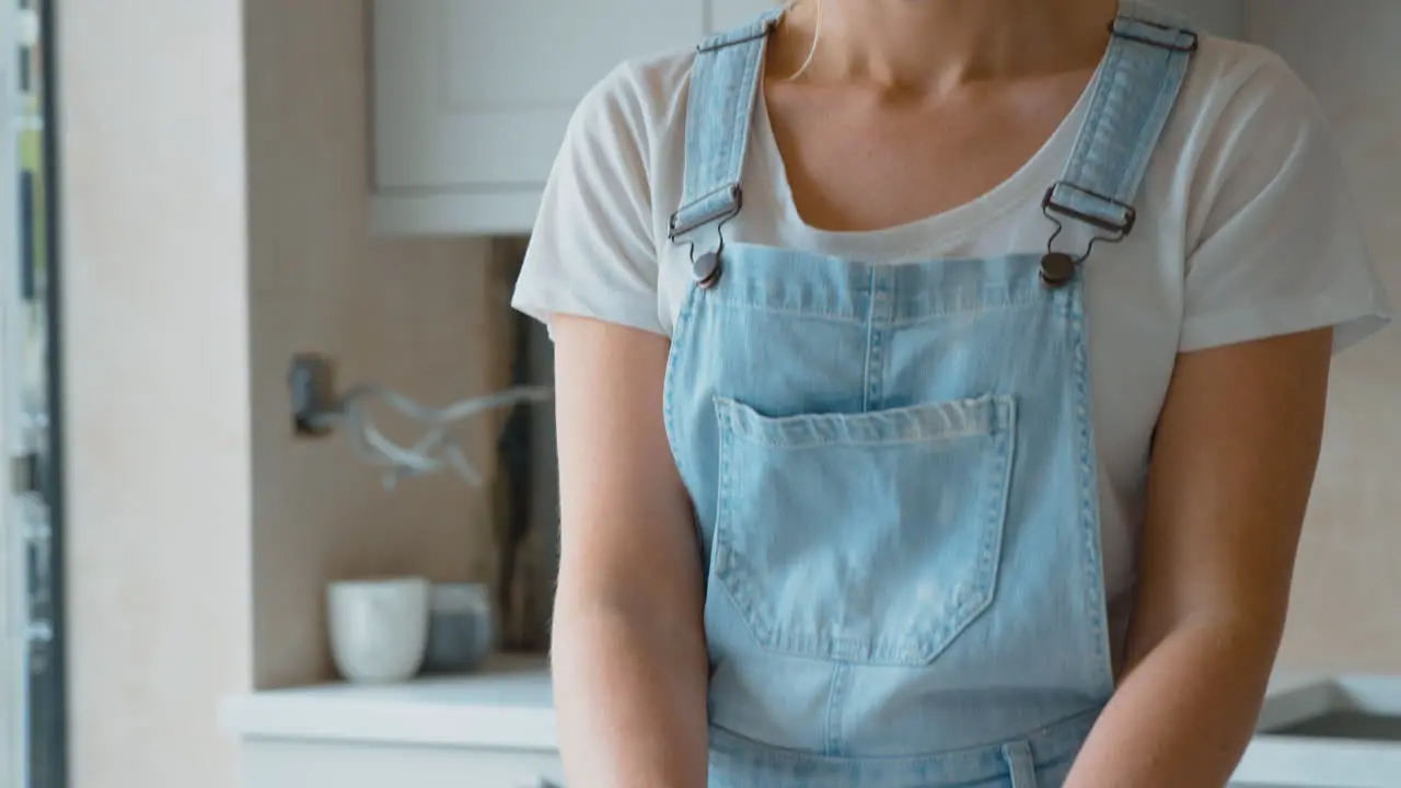 Woman Renovating Kitchen At Home Taking Picture Of Paint Colour Swatches On Mobile Phone