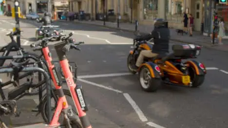 Close Up Shot of Electric Scooters as Traffic Goes Past