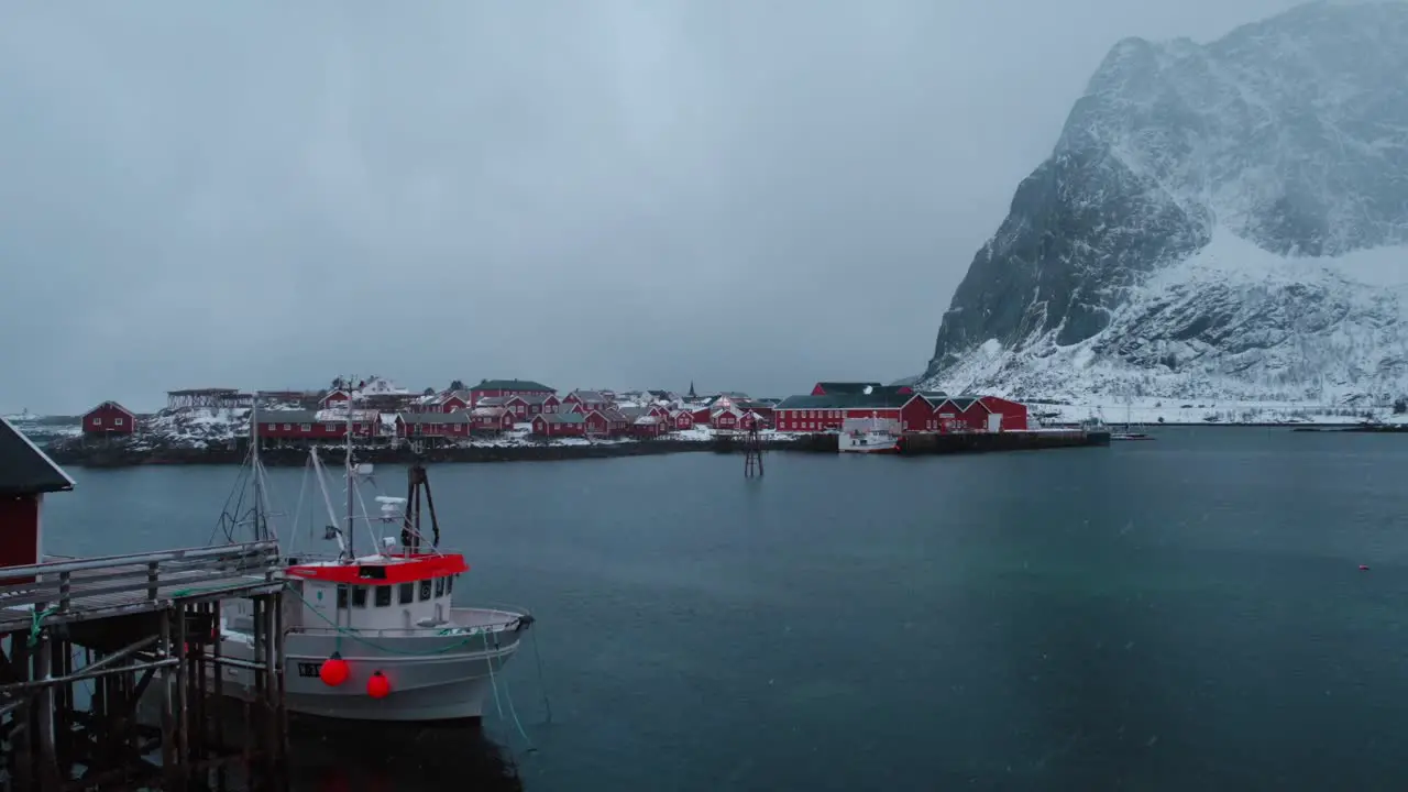 Drone footage of snow falling in the mountains of Reine Lofoten Islands in Norway