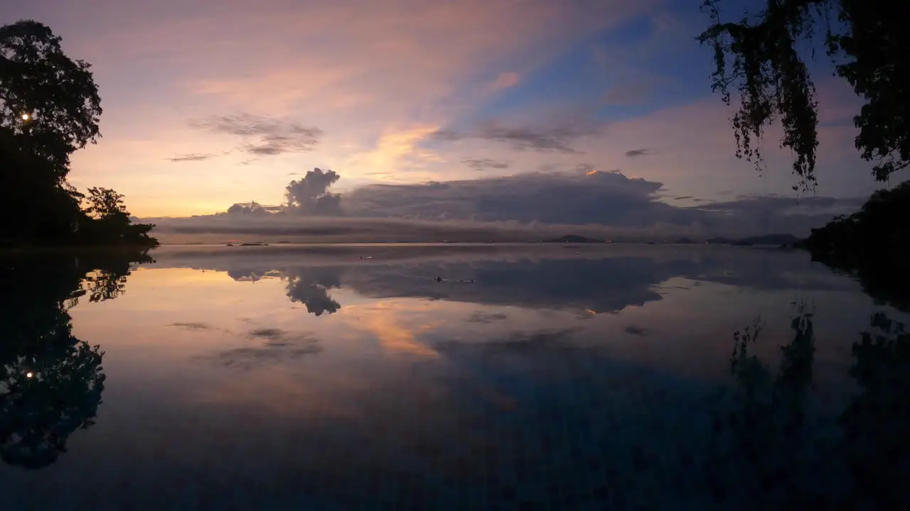 infinity pool overlooking the path of the panama canal mirroring the sunrise