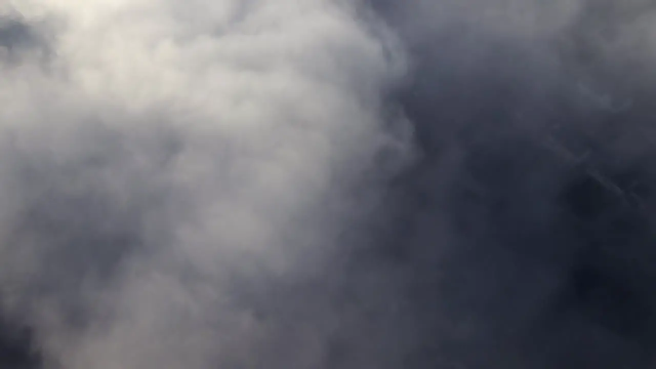 Aerial video from above the skies filming straight downwards at a layer of clouds