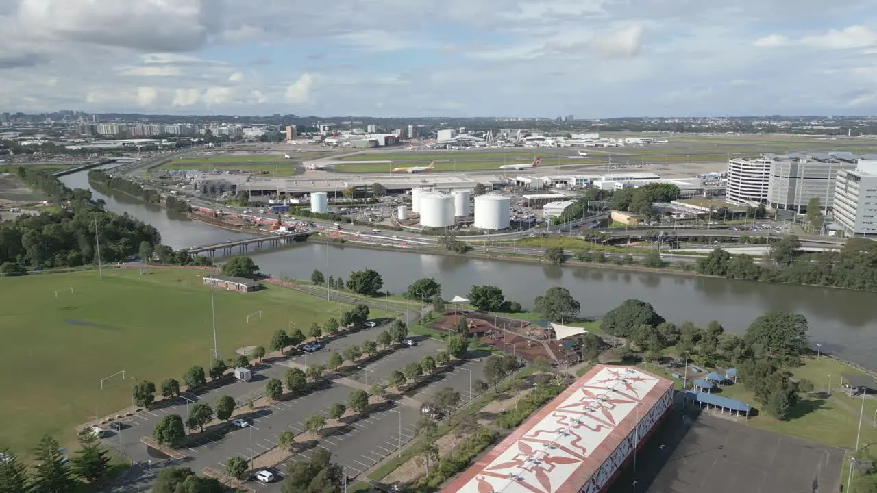 Aerial panning shot of Sydney Airport from the park in the neighborhood