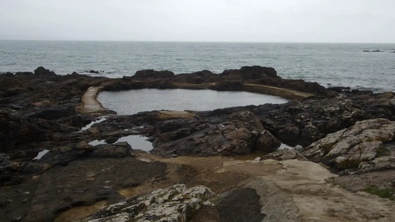 extra wide shot at Low-level shot of Mousehole Rock Pool tidal swim pool Cornwall