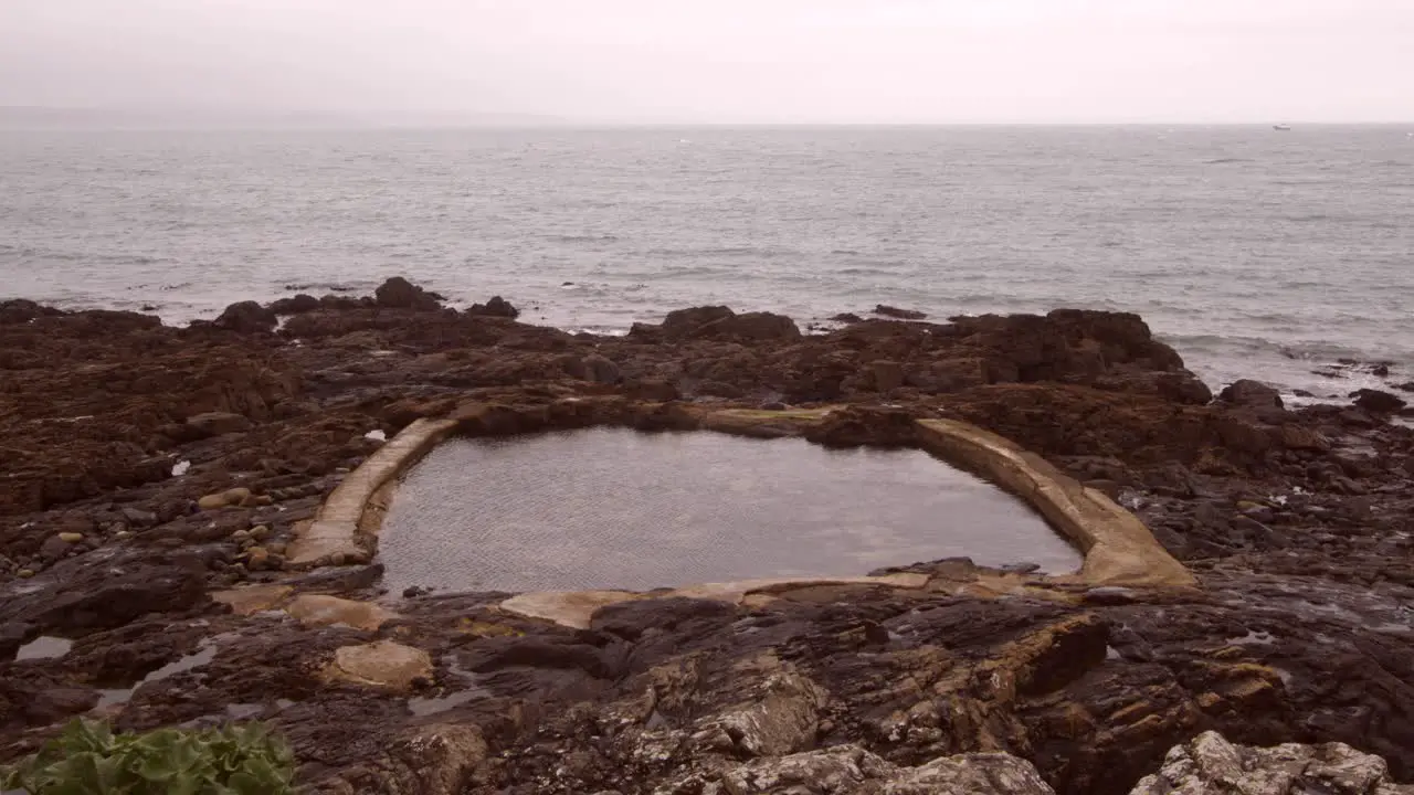 Wide shot at Low-level shot of Mousehole Rock Pool tidal swim pool Cornwall