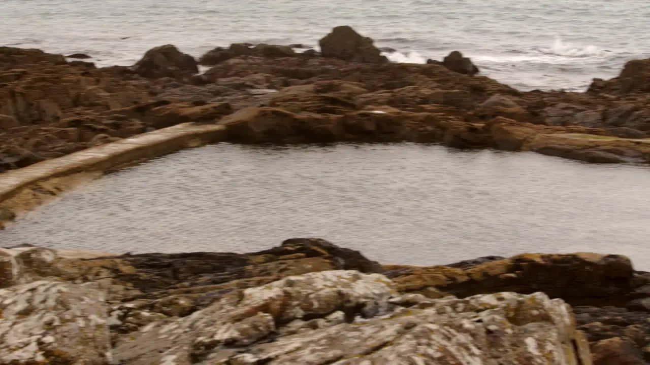 Low-level shot of Mousehole Rock Pool tidal swim pool Cornwall