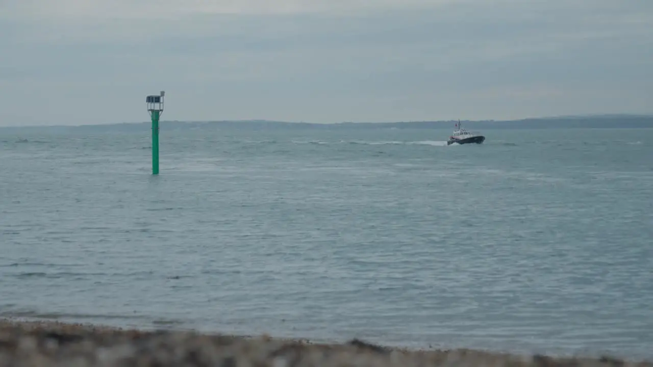 Alternative wide of boats sailing in the channel with the Isle of Wight in the background on a cloudy day