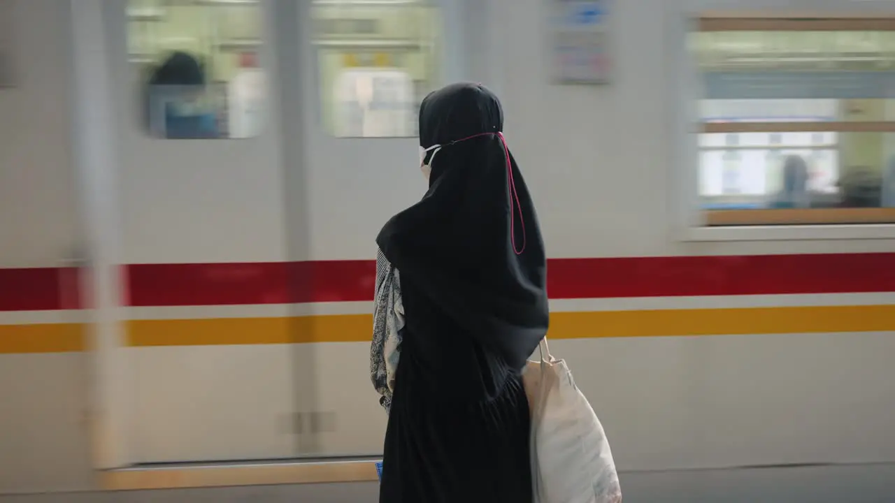 Mid Shot of a Woman Waiting for Train in Jakarta