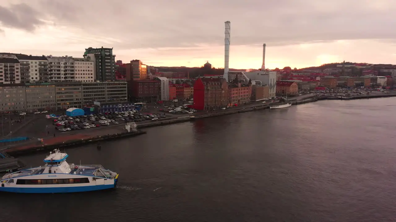 Aerial drone flight over smooth waters at harbor area in Gothenburg Sweden at sunset