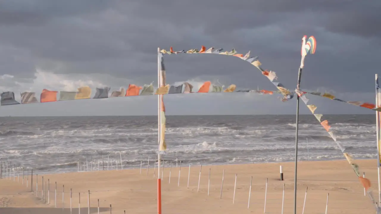 Colorful Flags On The Beach Of De Haan On The Belgian Coast At The North Sea wide