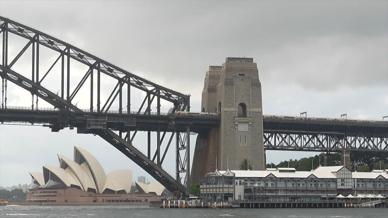 A train passes over the Sydney Harbour Bridge on a cloudy rainy day Australia