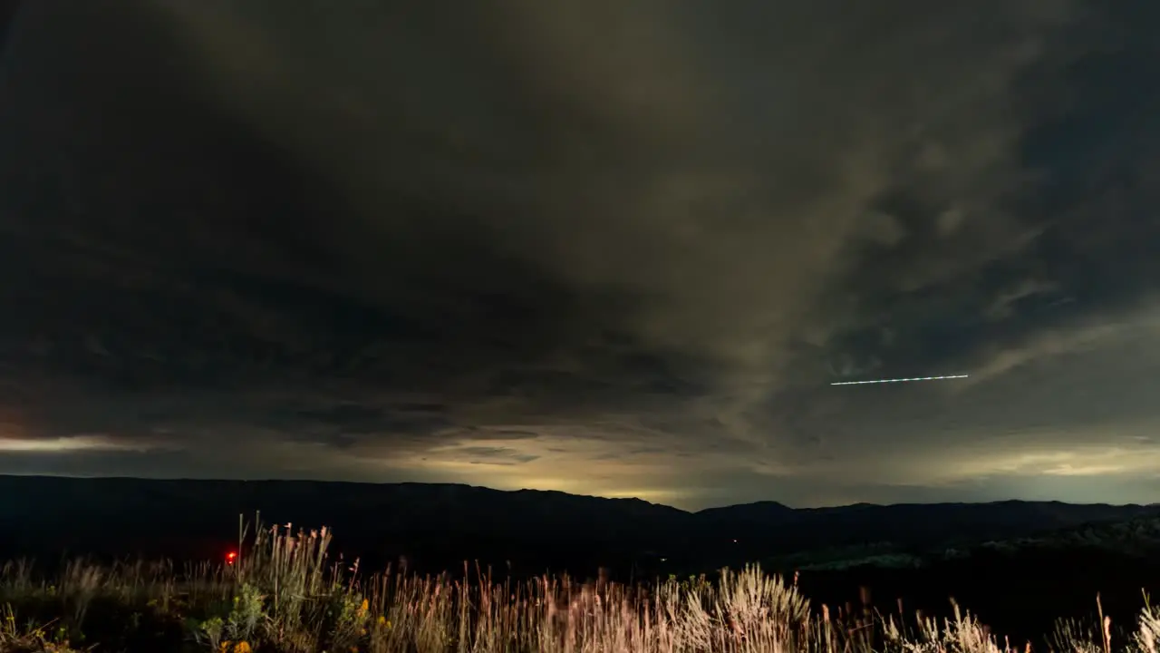 Nighttime cloudscape over the mountains time lapse