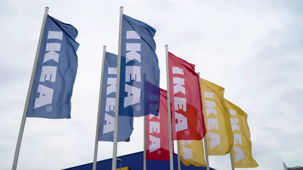 Ikea Flags Blowing in the Wind next to Blue Storefront on Cloudy Day