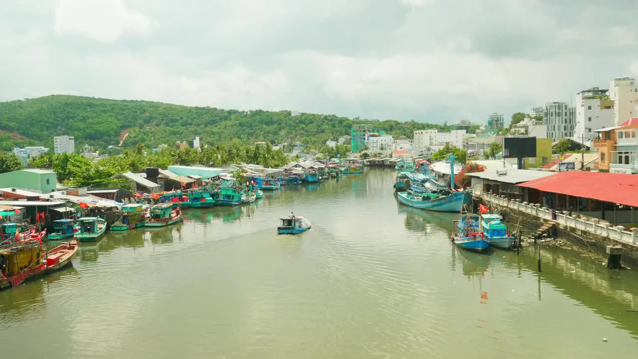 Little wooden boat sailing a river in tropical picturesque floating village