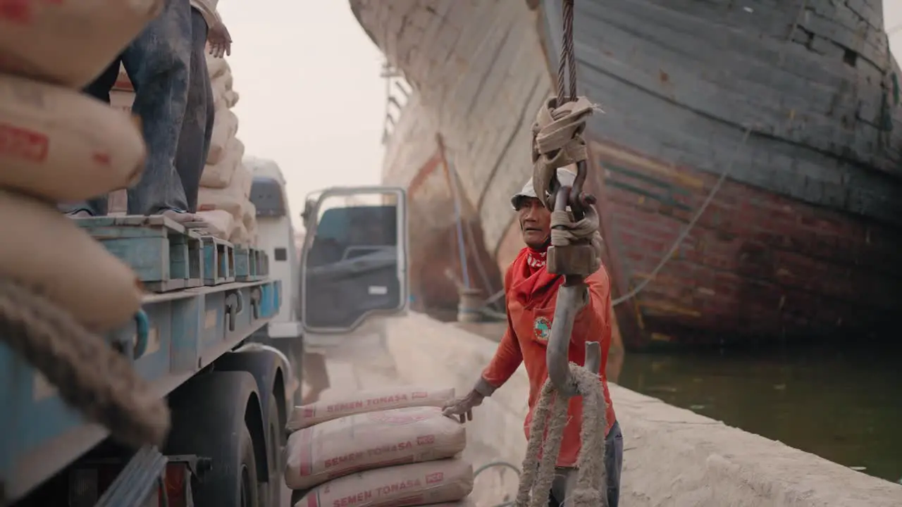 Mid Shot of Men Unloading Truck