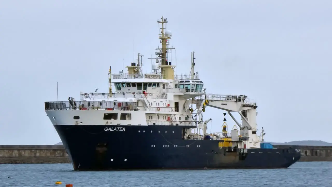 THV Galatea lighthouse tender ship navigating Holyhead breakwater harbour coastline