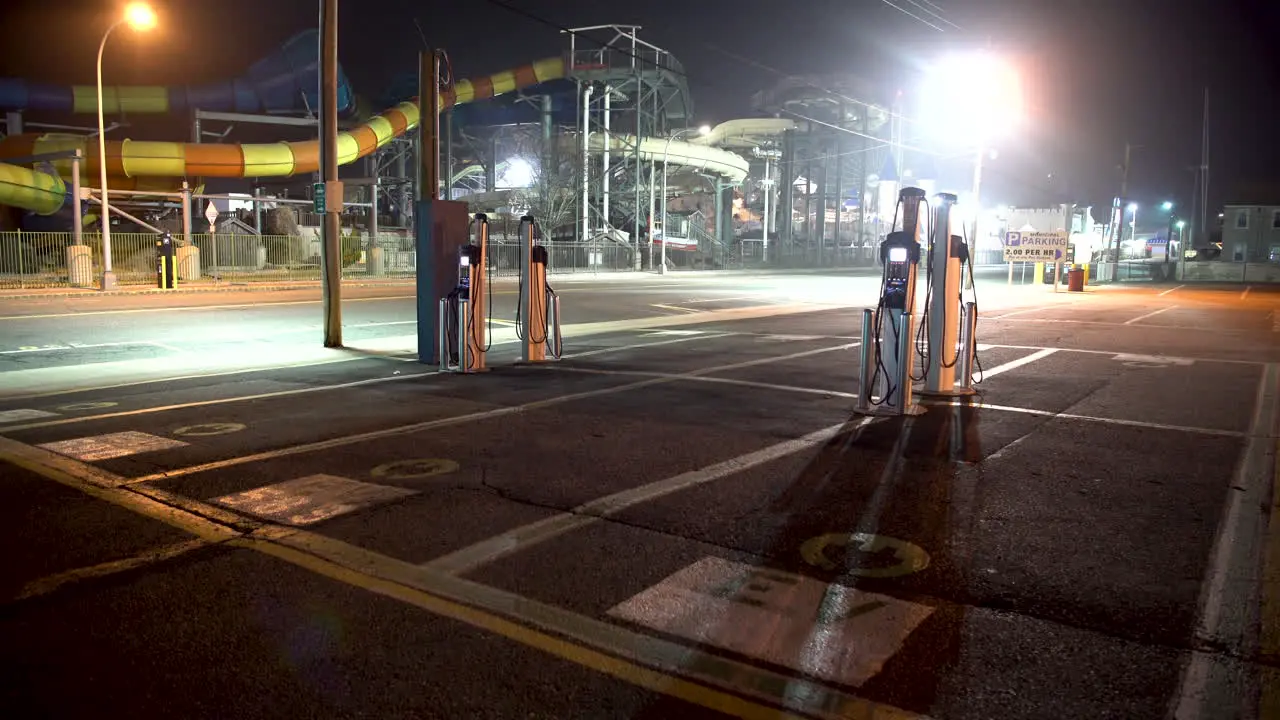 Electric car charging station at night in an empty parking lot