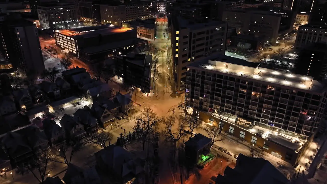 Drone tilting over snowy streets revealing the Wisconsin State Capitol night in Madison USA