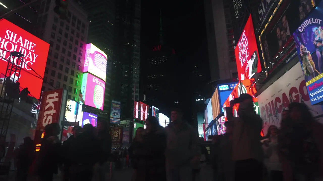 Driving past colorful banners and ads at the Times square night in New York